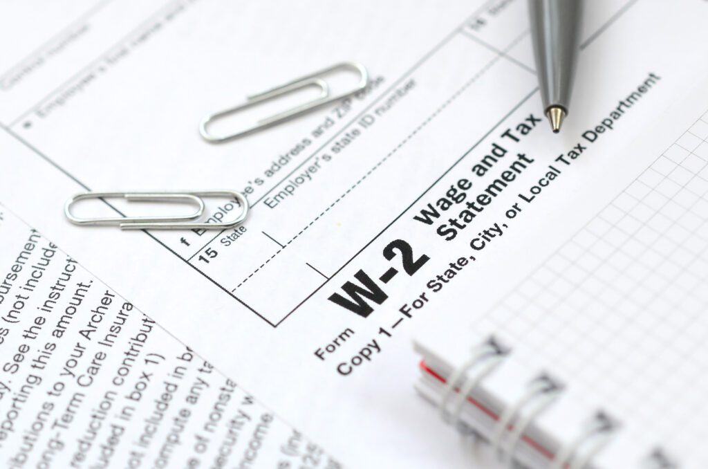 W-2 Form with pen and notebook